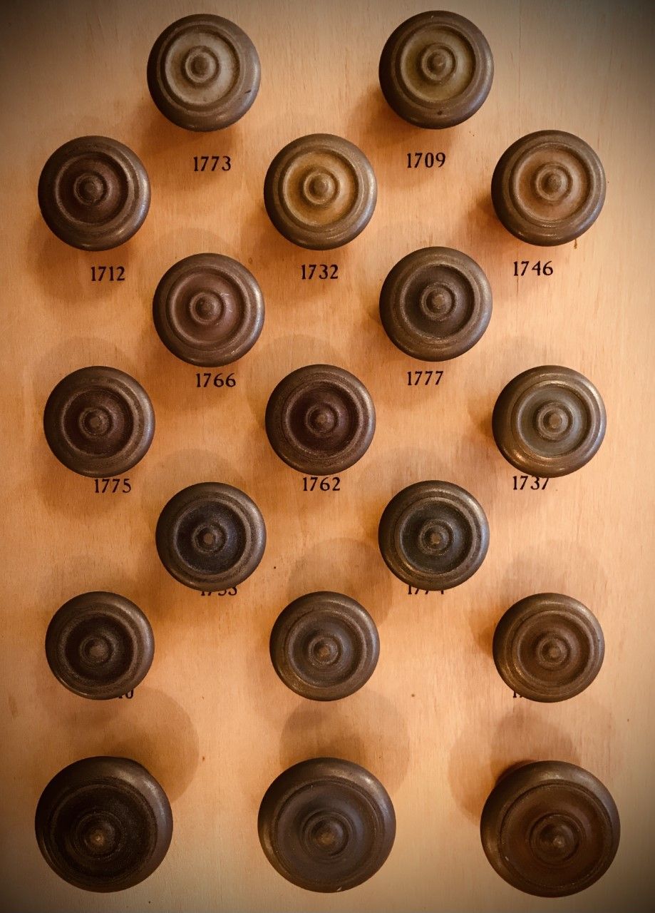 Wooden wheels mounted on a panel, each labeled with a year from the 18th century.