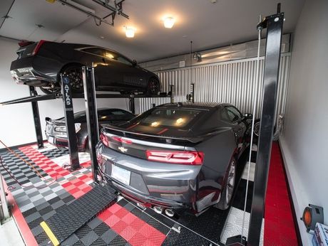 Photo of a luxury car about to be raised on a parking lift