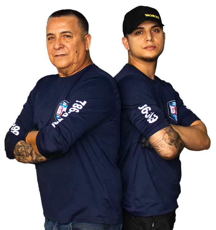 Two men are standing back to back with their arms crossed