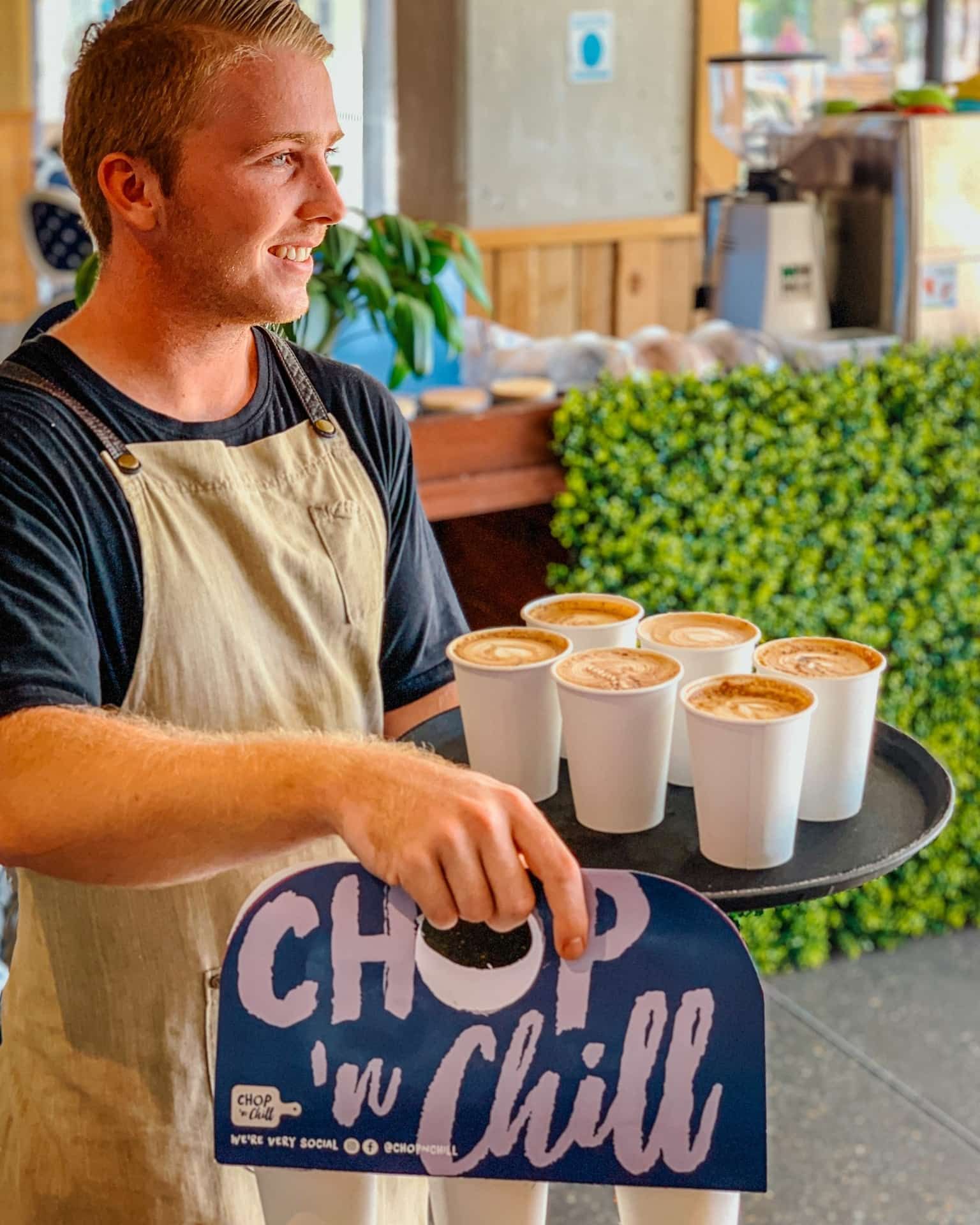 A Man Is Holding a Tray of Coffee Cups — Chop 'n Chill South West Rocks in South West Rocks, NSW