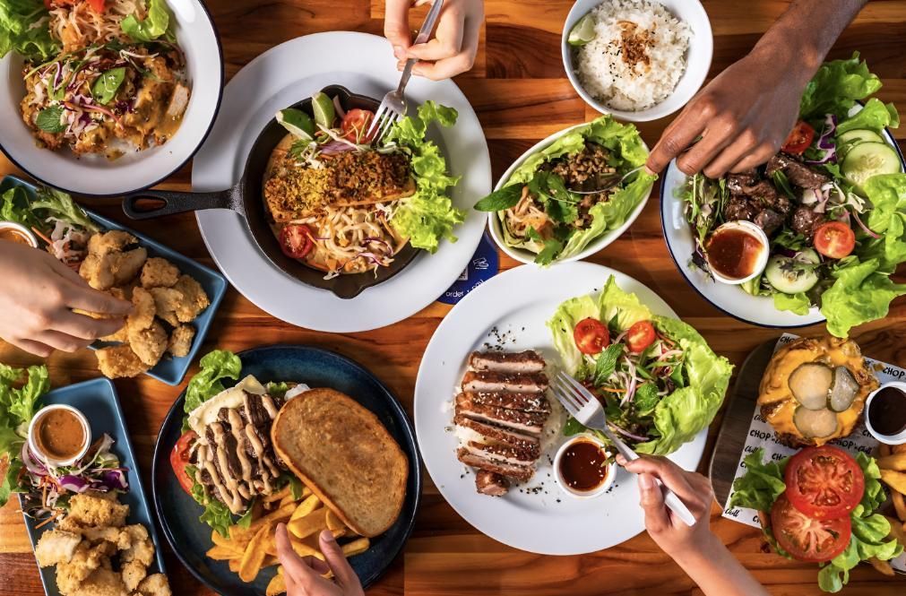 A Group of People Are Sitting at a Tabl — Chop 'n Chill South West Rocks in South West Rocks, NSW