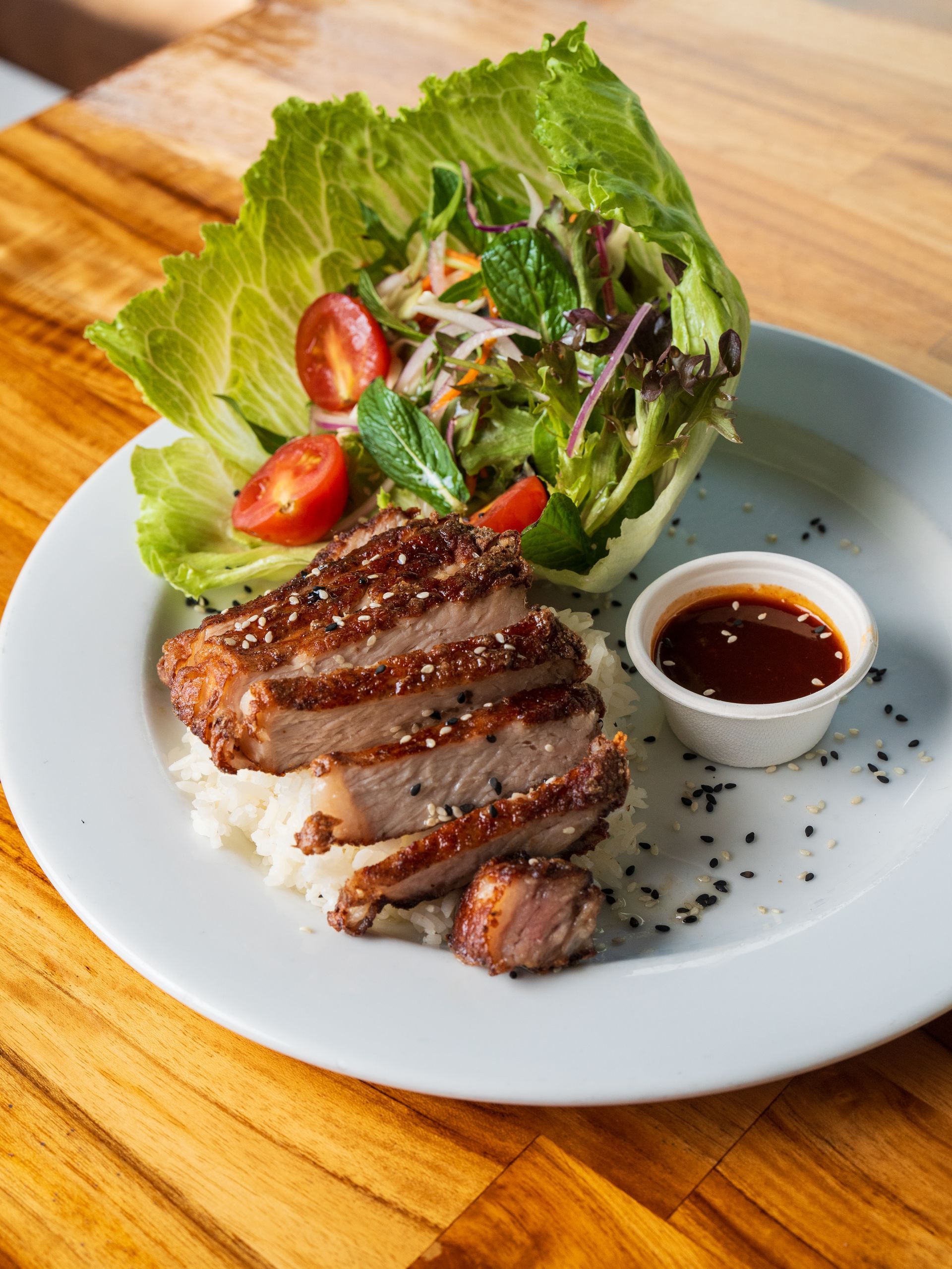 A White Plate Topped With Meat, Rice, Lettuce and Tomatoes — Chop 'n Chill South West Rocks in South West Rocks, NSW