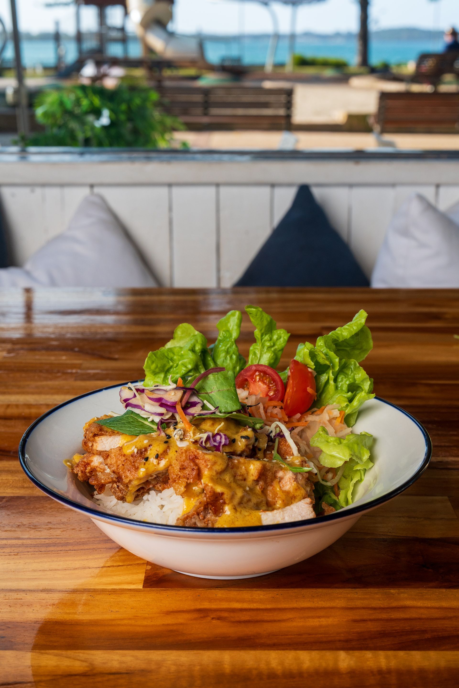 A Bowl of Food is Sitting on a Wooden Table — Chop 'n Chill South West Rocks in South West Rocks, NSW