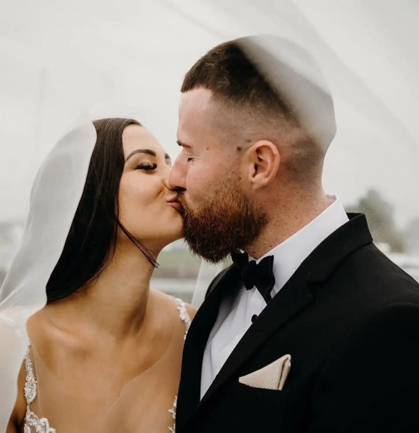 A Bride and Groom Kissing Under a Veil on Their Wedding Day — Chop 'n Chill South West Rocks in South West Rocks, NSW