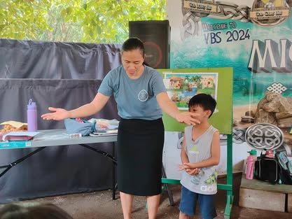 A woman is giving a presentation to a young boy.