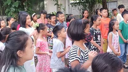 A group of children are standing in a line.