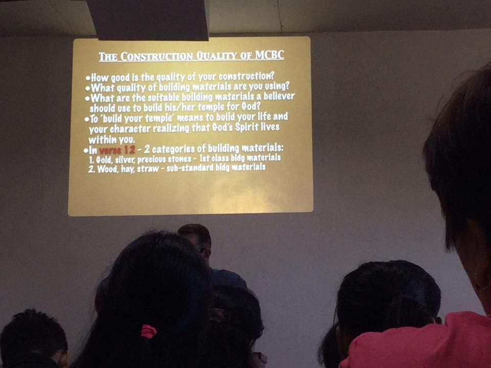 A group of people watching a presentation about the construction quality of mcbc