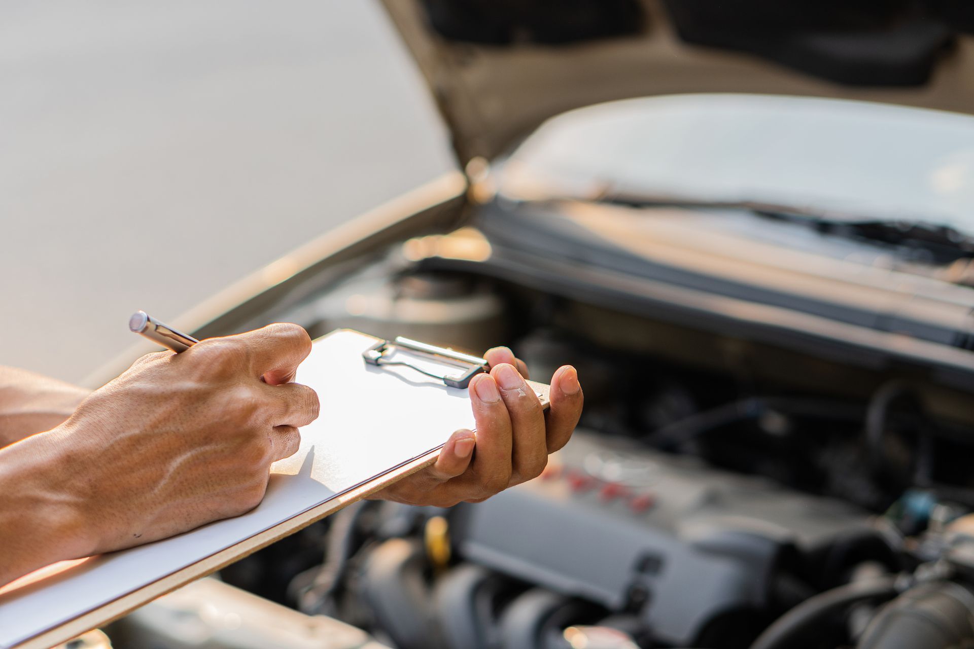 A man is installing a windshield on a car.