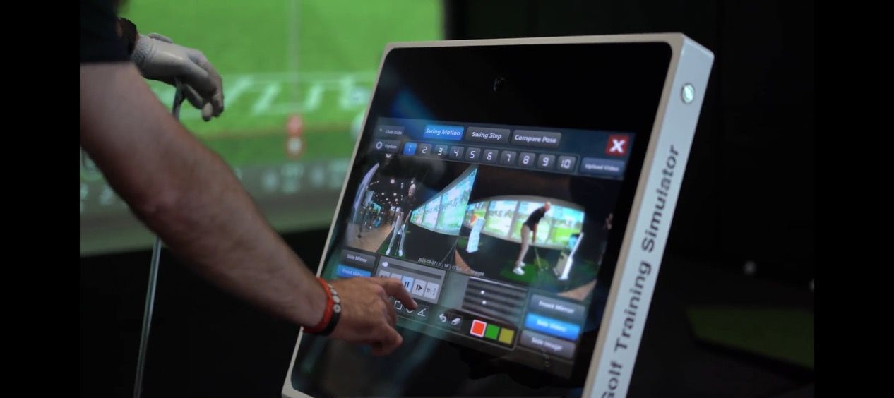 a person is using a golf training simulator