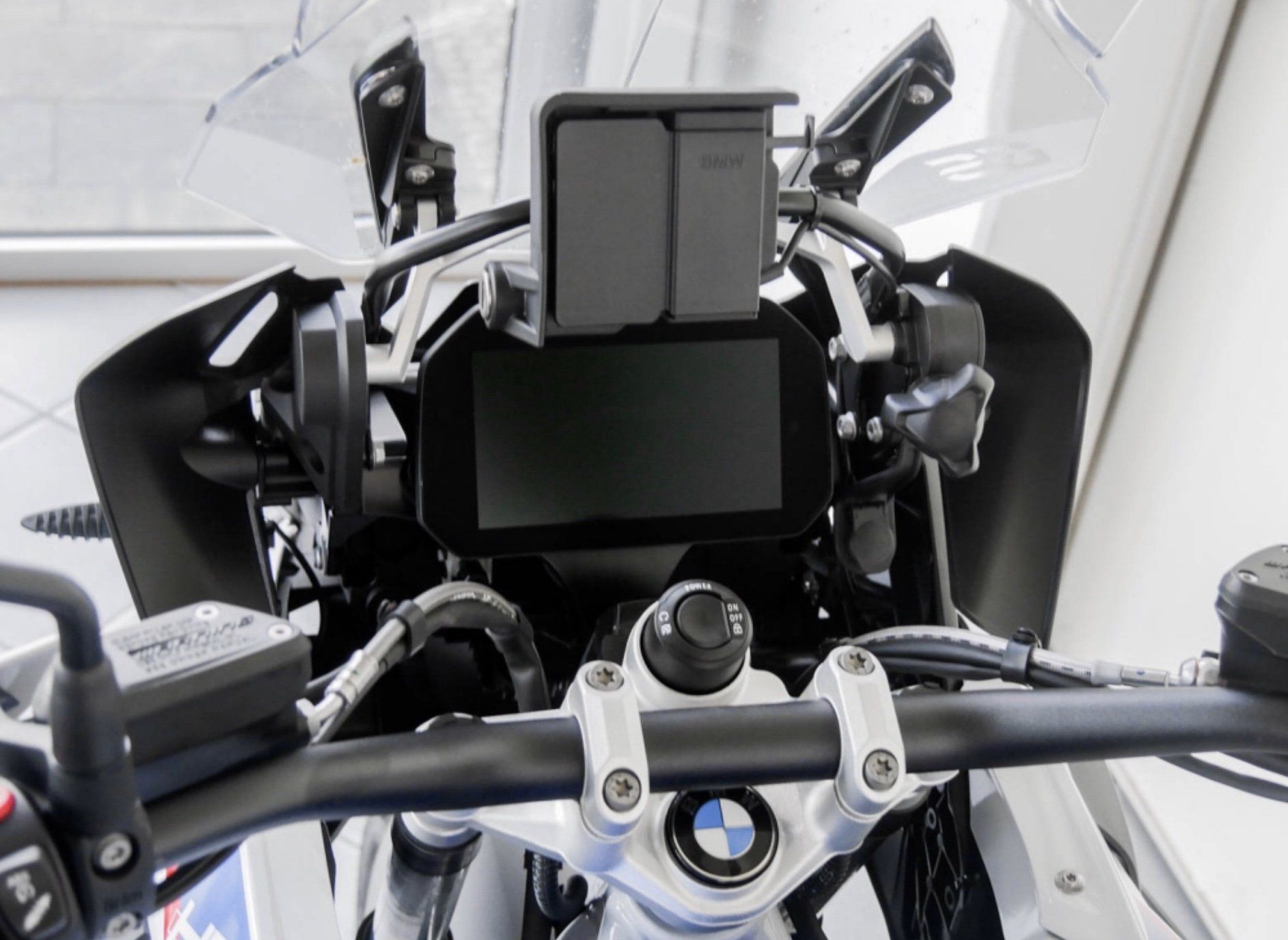 Ein Motorrad von oben gesehen mit dem Blick auf das Navigationssystem und dem Lenker.