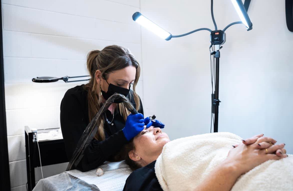 Woman Receiving Eyebrow Microblading Treatment — Artisan Cosmetic Tattoo & Beauty in Worongary, QLD