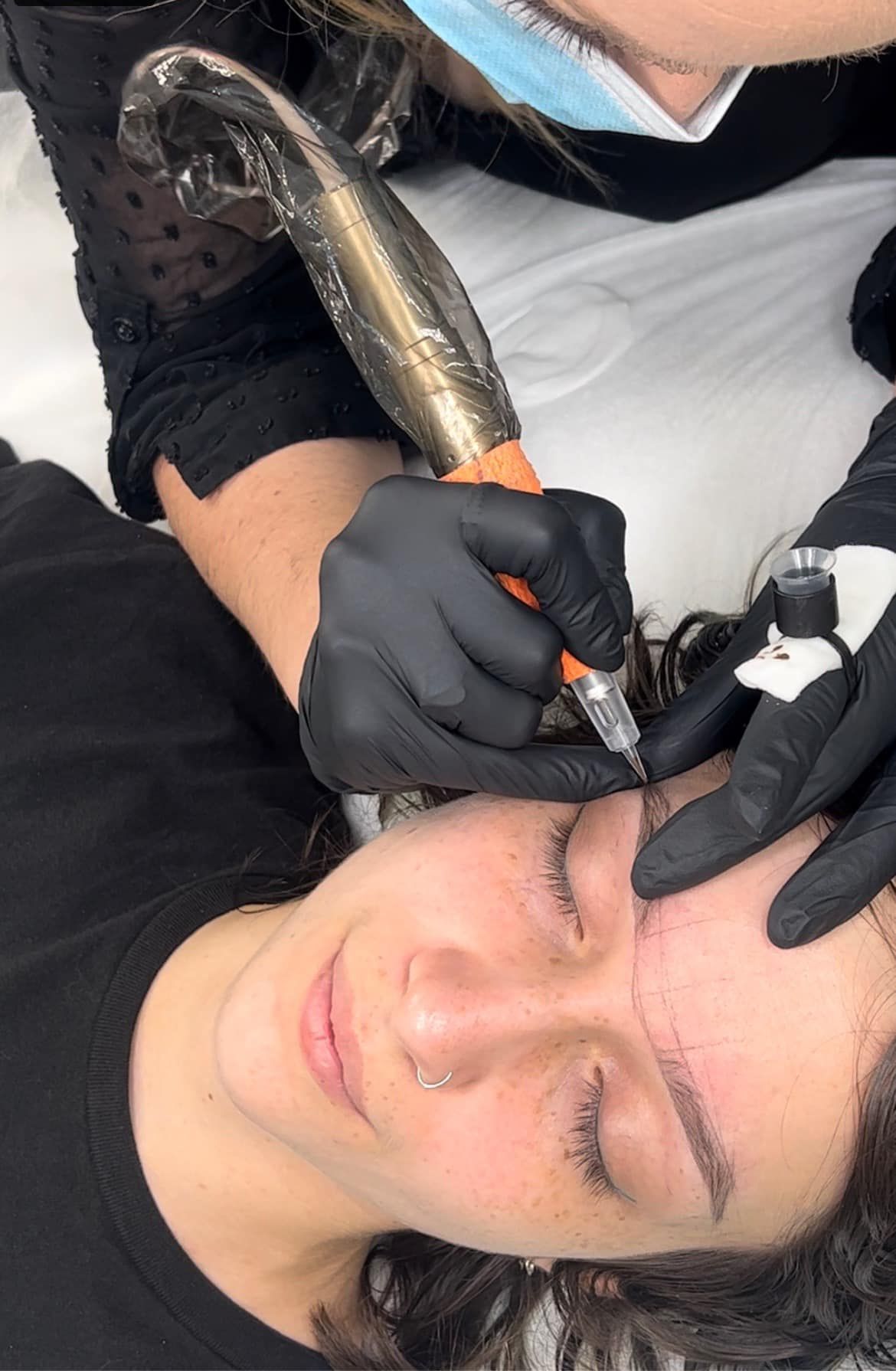 Person Receiving Microblading on Their Eyebrow  — Artisan Cosmetic Tattoo & Beauty in Worongary, QLD