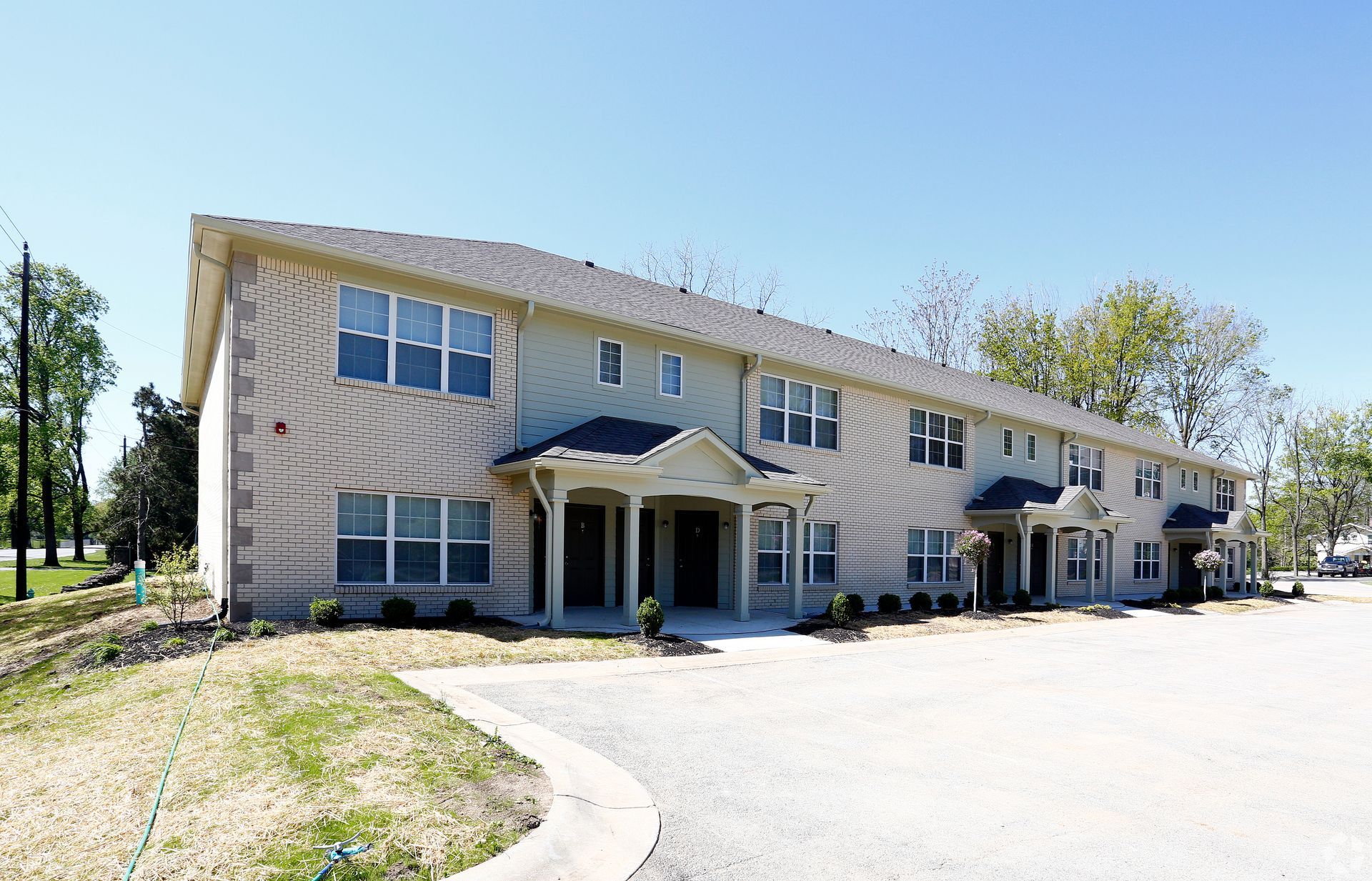 A large apartment building with a lot of windows on a sunny day