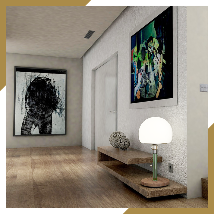 A hallway with a lamp and two paintings on the wall