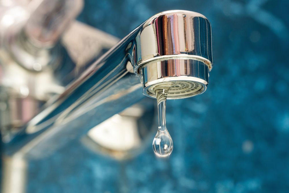 A Close Up Of A Water Faucet With A Drop Of Water Coming Out Of It - San Diego, CA - S.O.S. Affordable Rooter Plumbing