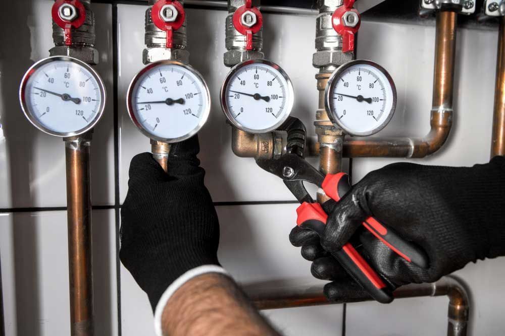 A Plumber is Working on a Pipe With a Pair of Pliers — Tony Brown Plumbing & Gas Services in South Grafton, NSW
