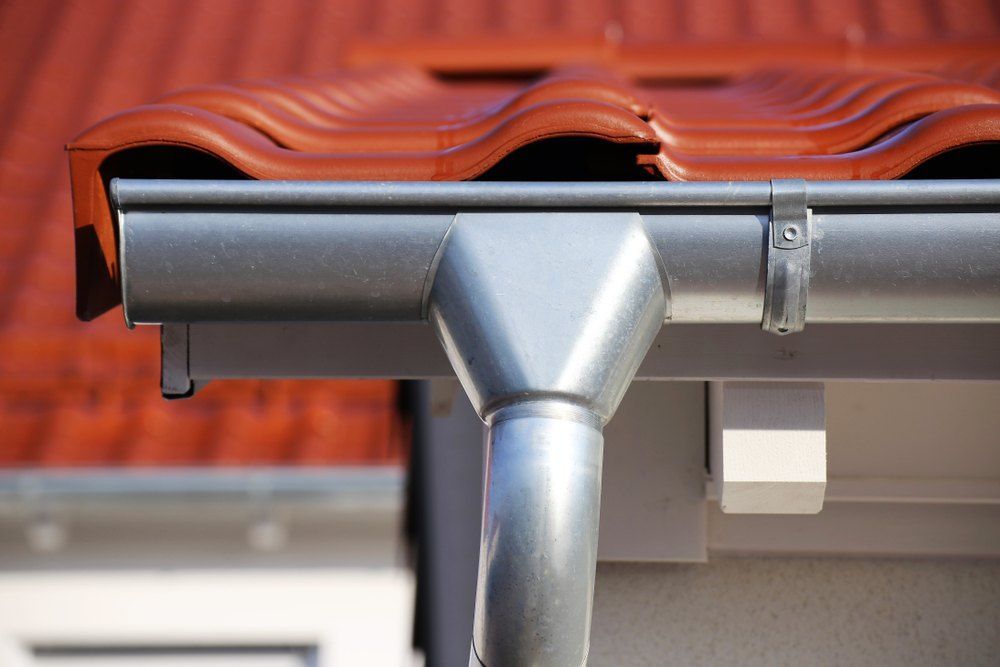 A Close Up of a Gutter on a Roof With a Red Tile Roof — Tony Brown Plumbing & Gas Services in South Grafton, NSW