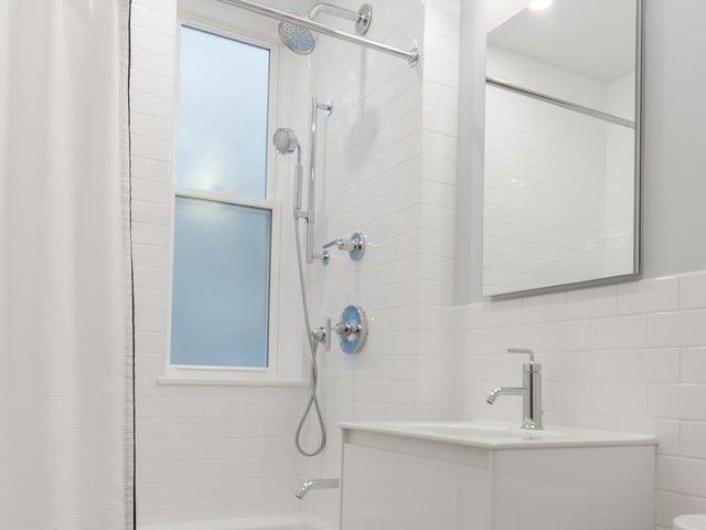 A Bathroom With a Toilet, Sink, Shower, and Window — Tony Brown Plumbing & Gas Services in South Grafton, NSW