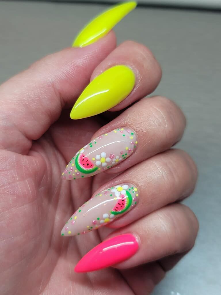 A close up of a person 's nails with a watermelon design.