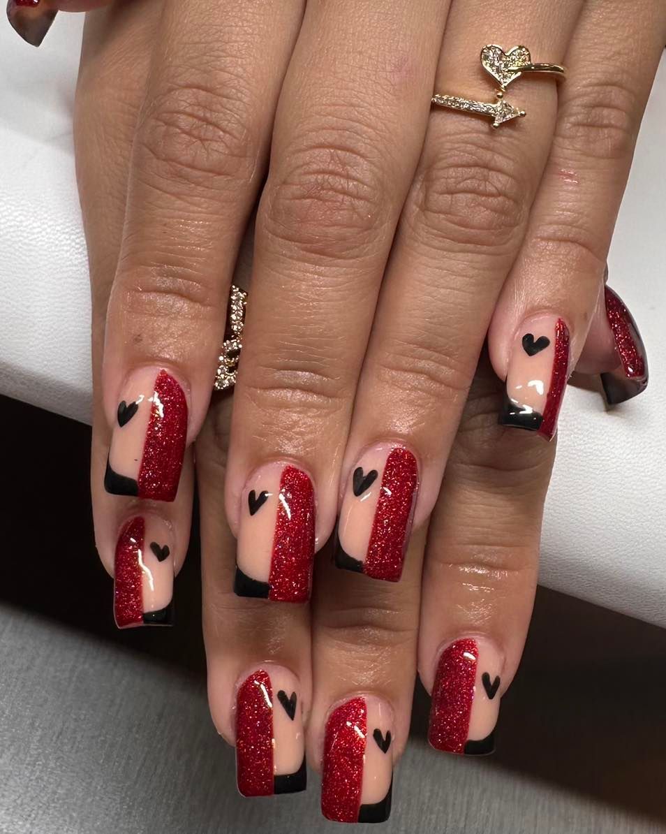 A close up of a woman 's nails with hearts on them