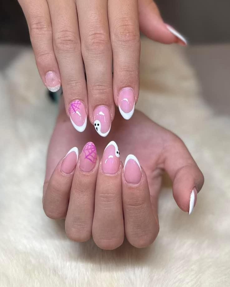A close up of a woman 's hands with pink and white nails.