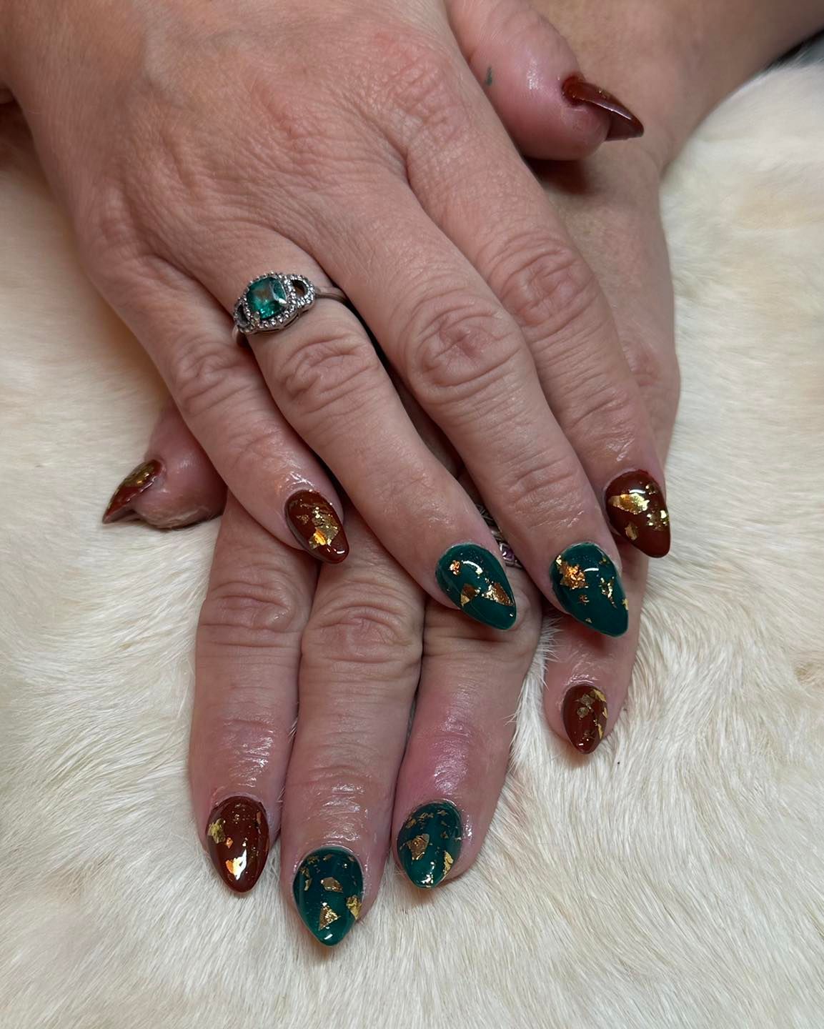 A close up of a woman 's hand with a ring on her finger.