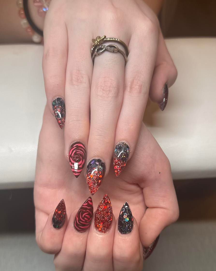 A close up of a woman 's nails with a ring on her finger.