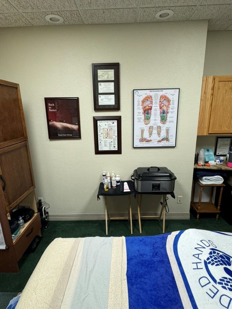 Person receiving facial massage in a spa setting; therapist's hands on face, eyes closed. Person receiving facial massage in a spa setting; therapist's hands on face, eyes closed.