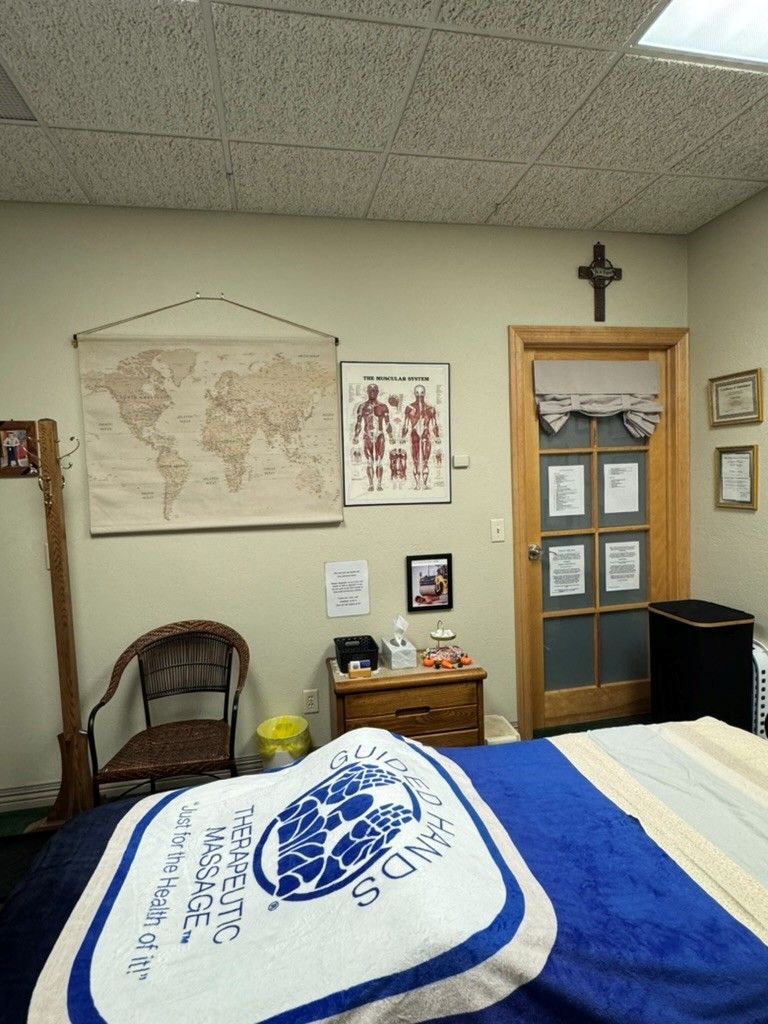 Woman receiving a facial massage with hands on her face, flowers around her head.