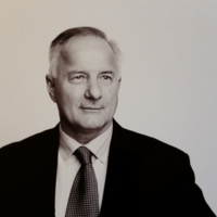 A black and white photo of a man in a suit and tie