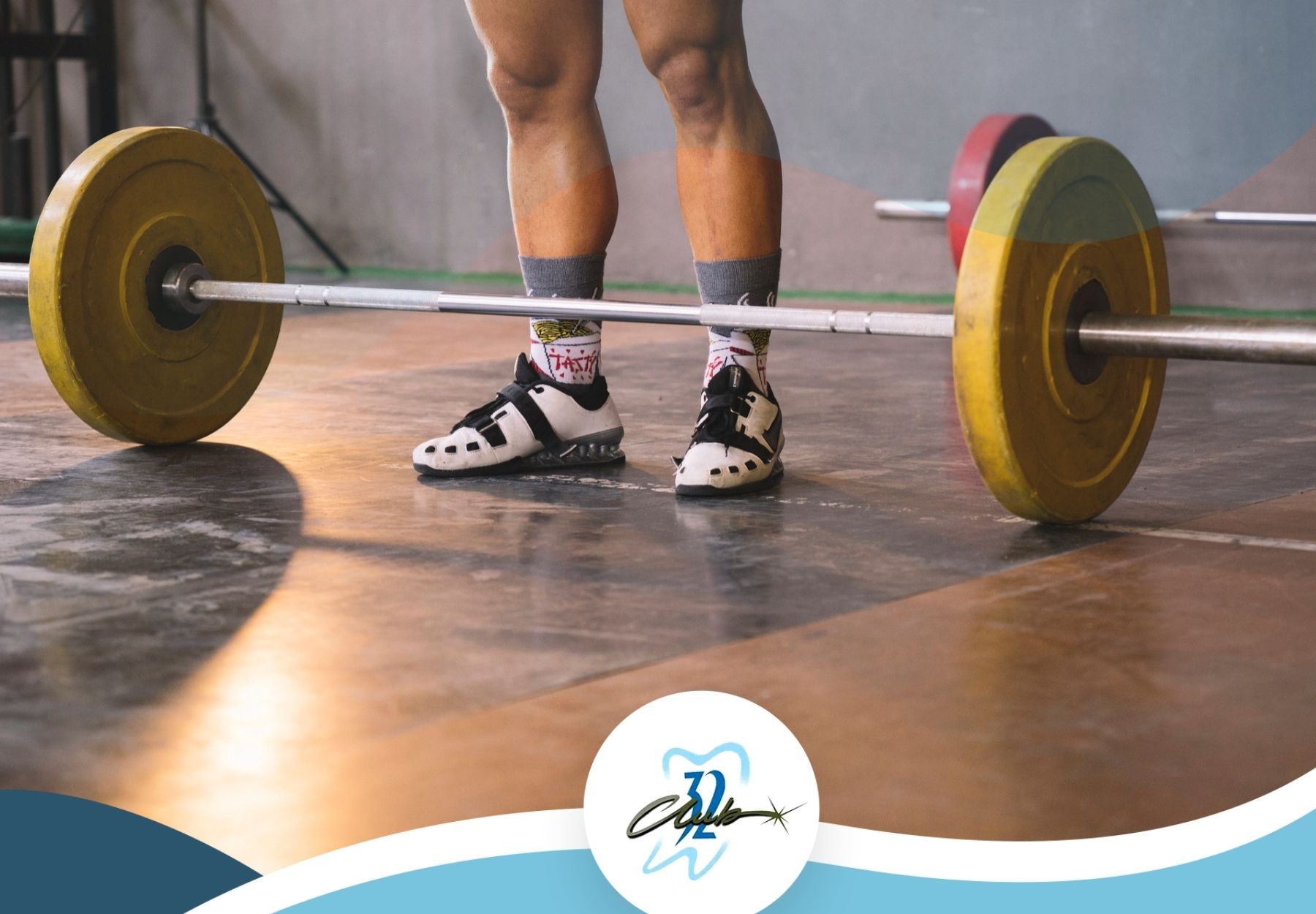 A person is lifting a barbell in a gym.