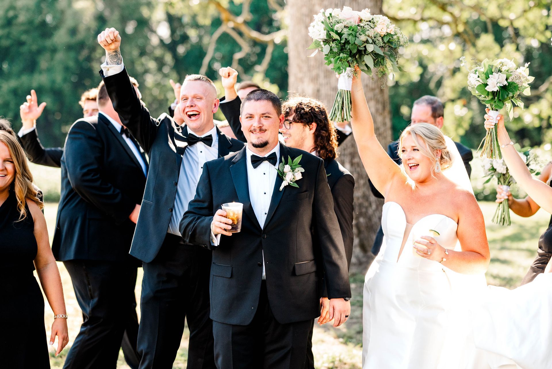 A bride and groom are walking down the aisle with their wedding party.