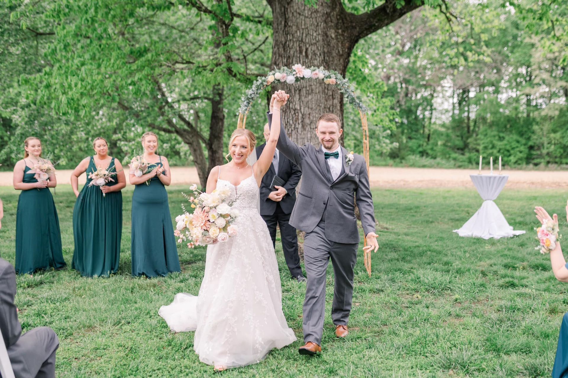 A bride and groom are walking down the aisle with their wedding party.