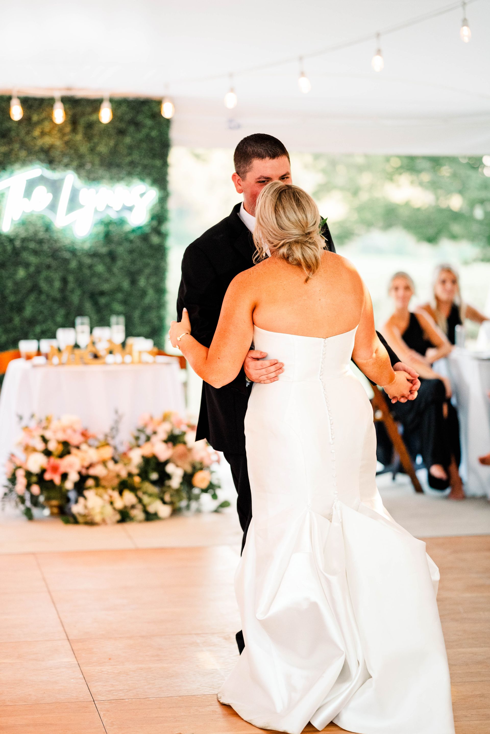 A bride and groom are dancing at their wedding reception.