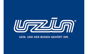 Logo di Uzin, testo bianco su sfondo blu. Il testo recita: