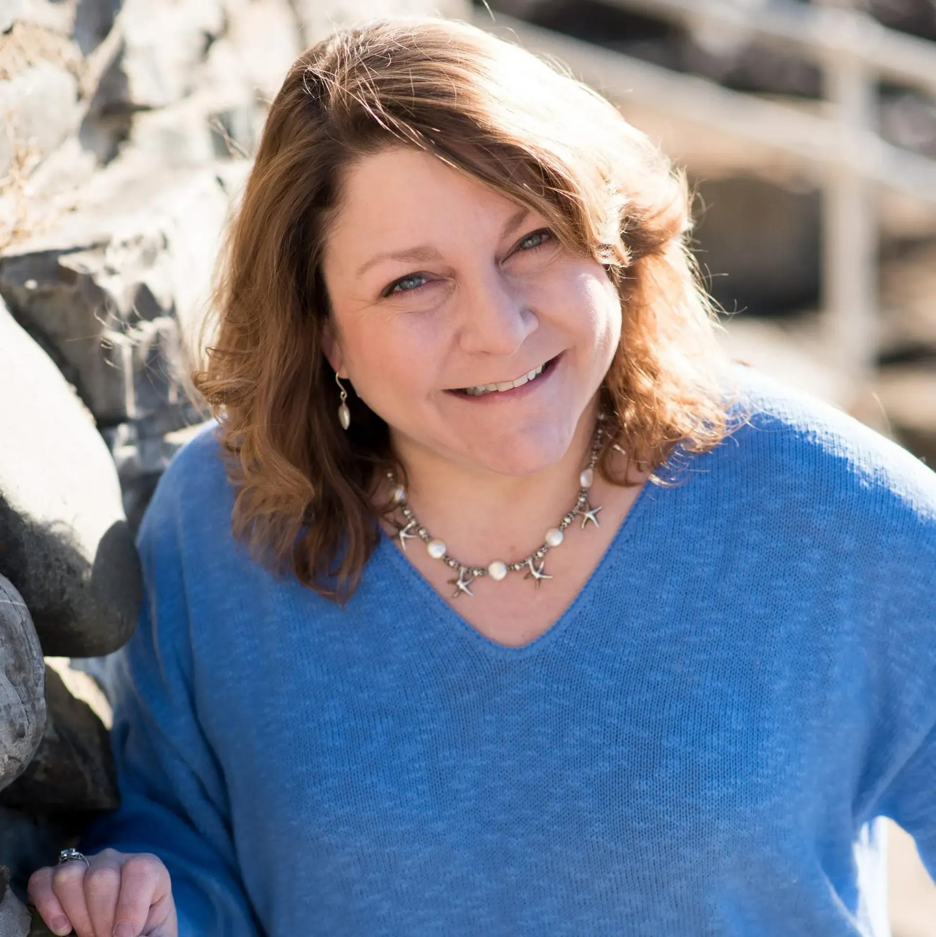 A close up of a woman 's face with long red hair.