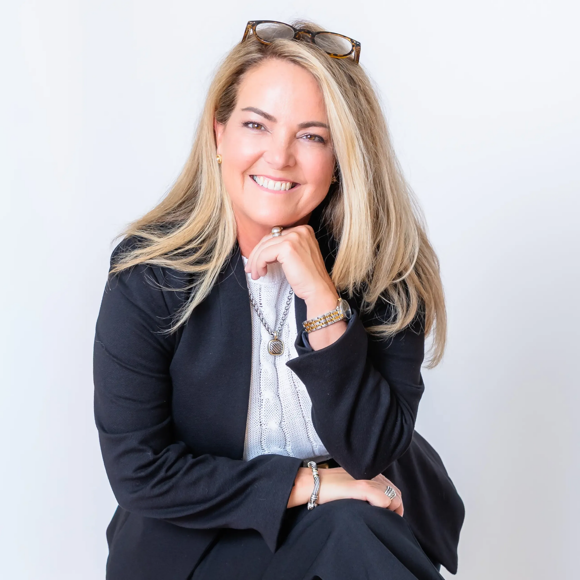 A woman stands in front of a sign that says ls