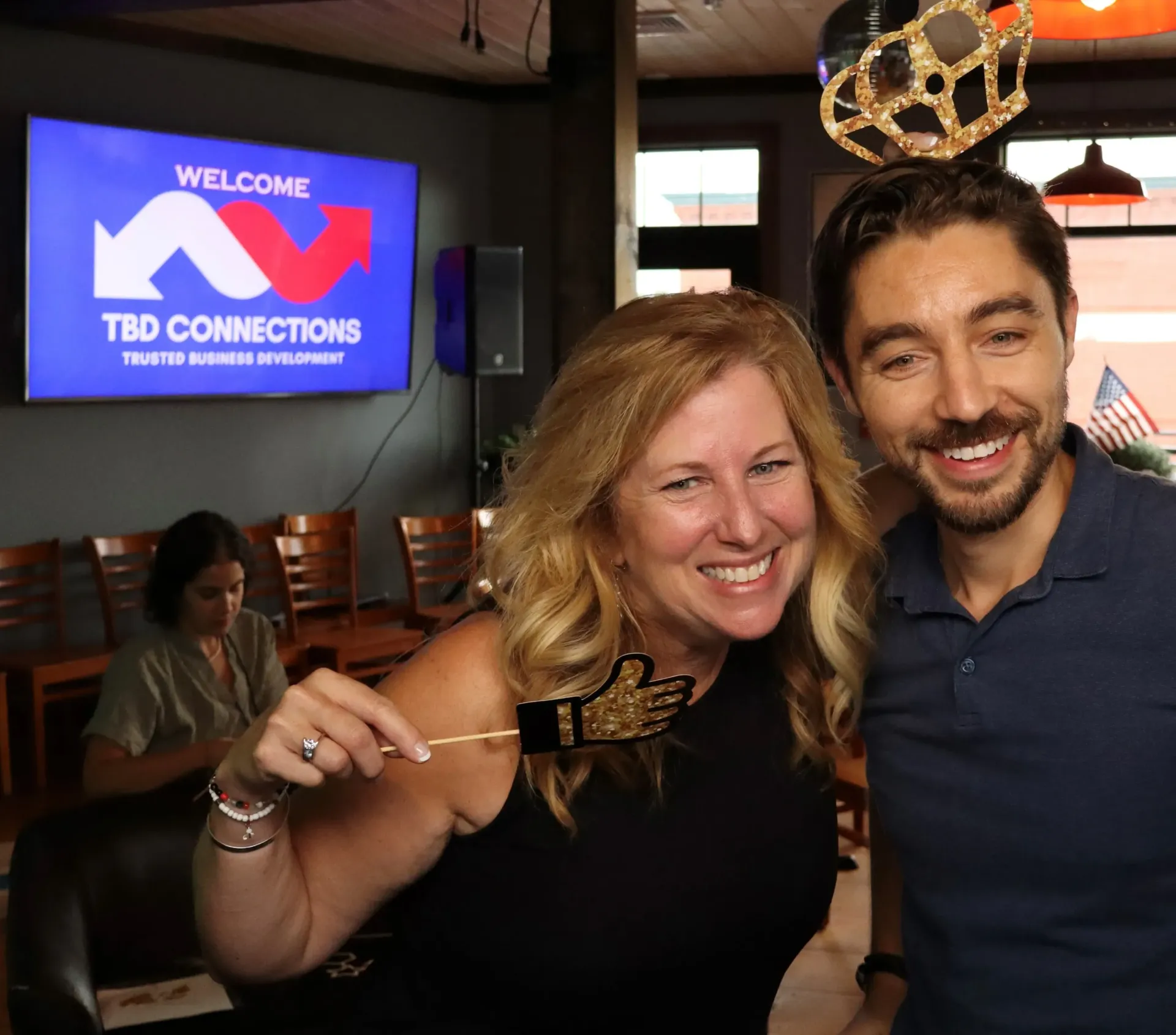 A man in a blue sweater is smiling for the camera