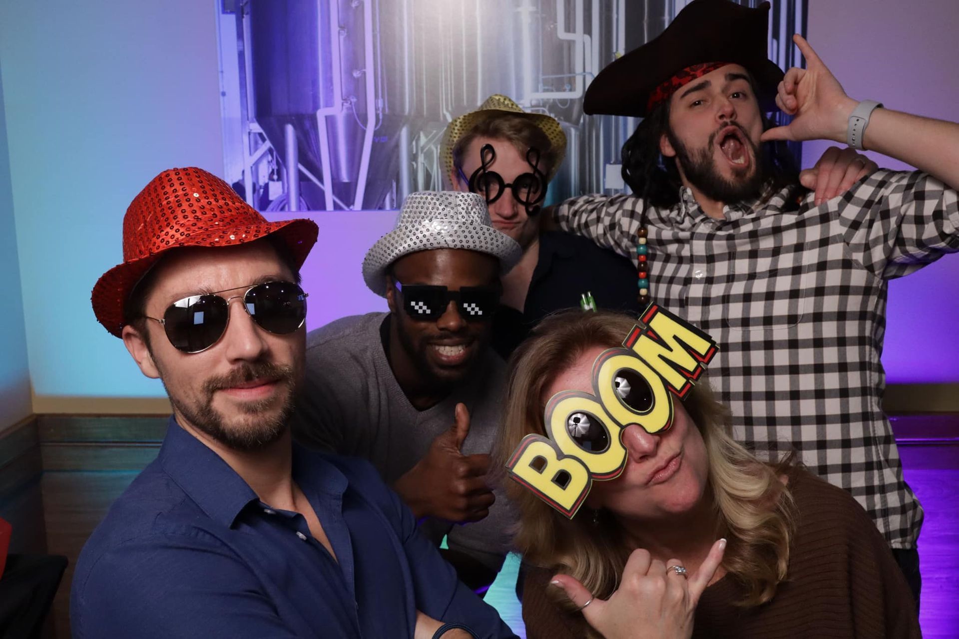 A group of people are posing for a picture in a photo booth.