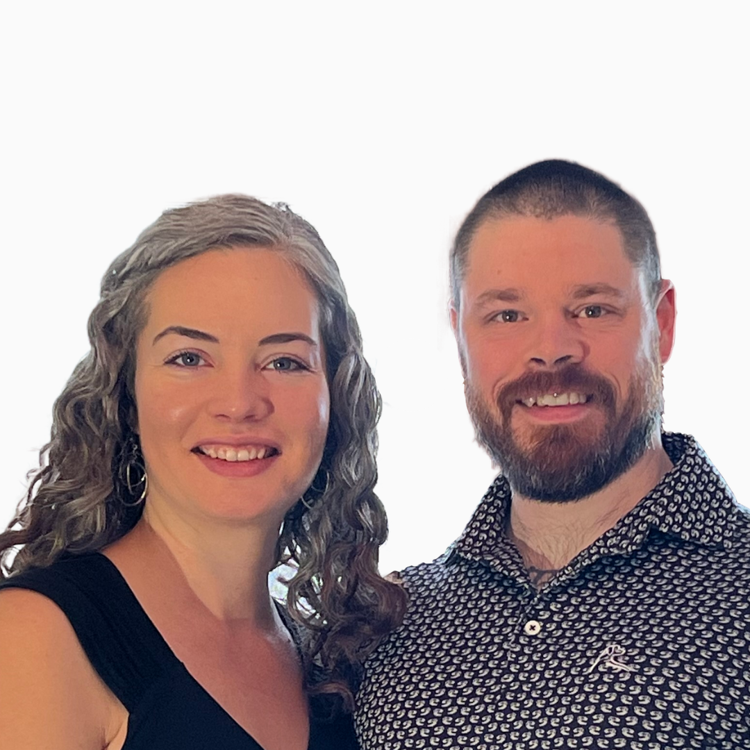 A man and a woman are posing for a picture and smiling for the camera.