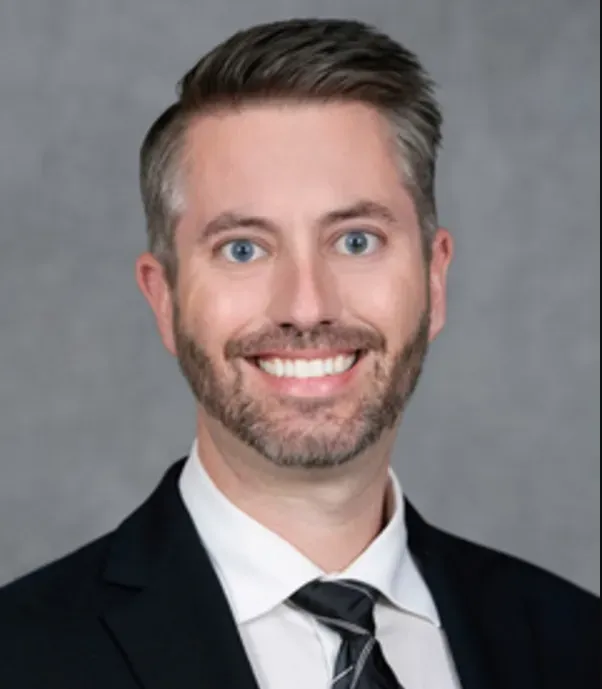 A woman stands in front of a sign that says ls