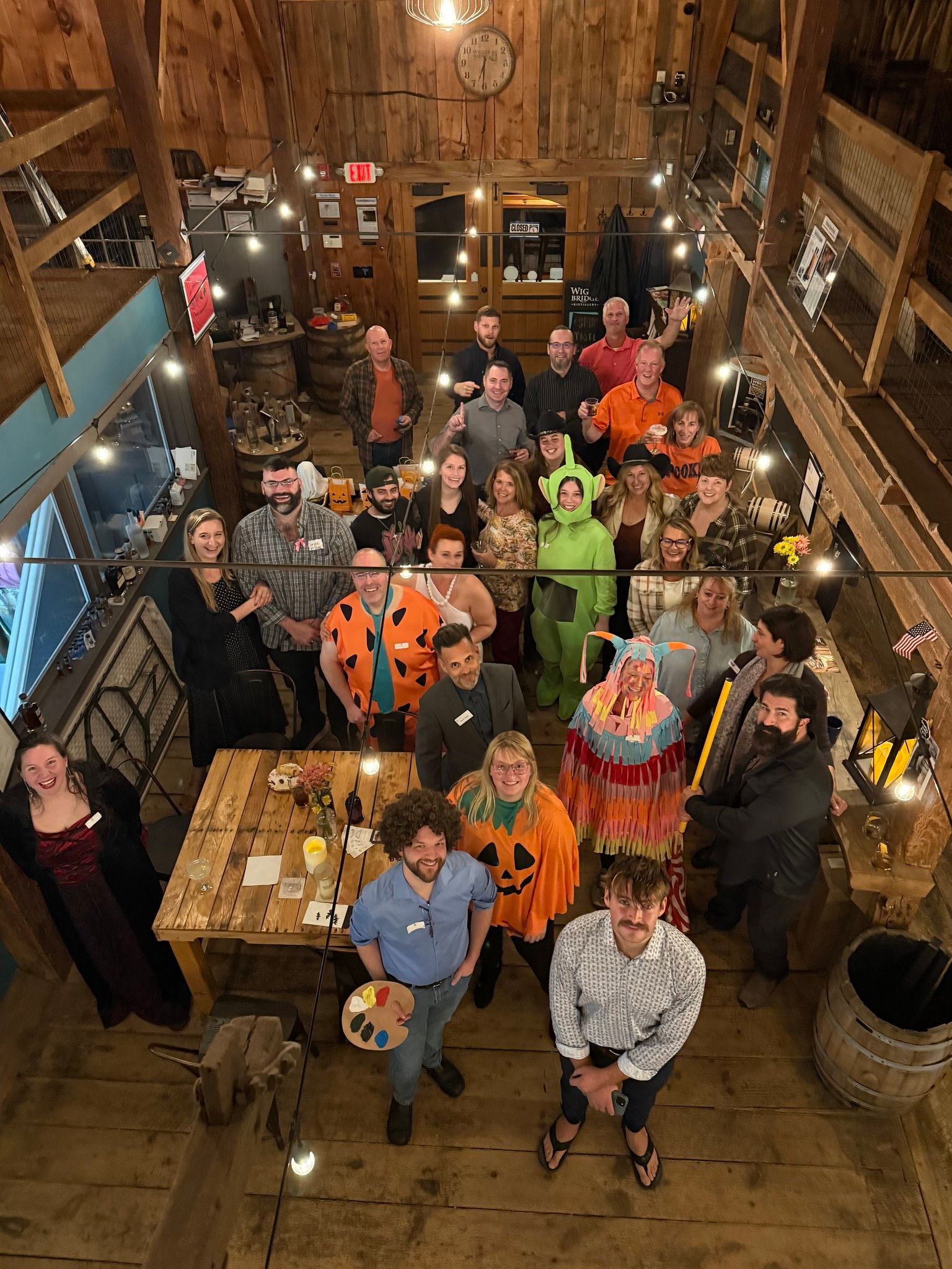 A large group of people part of TBD Connections Networking group are posing for a picture at Thompsons Point.
