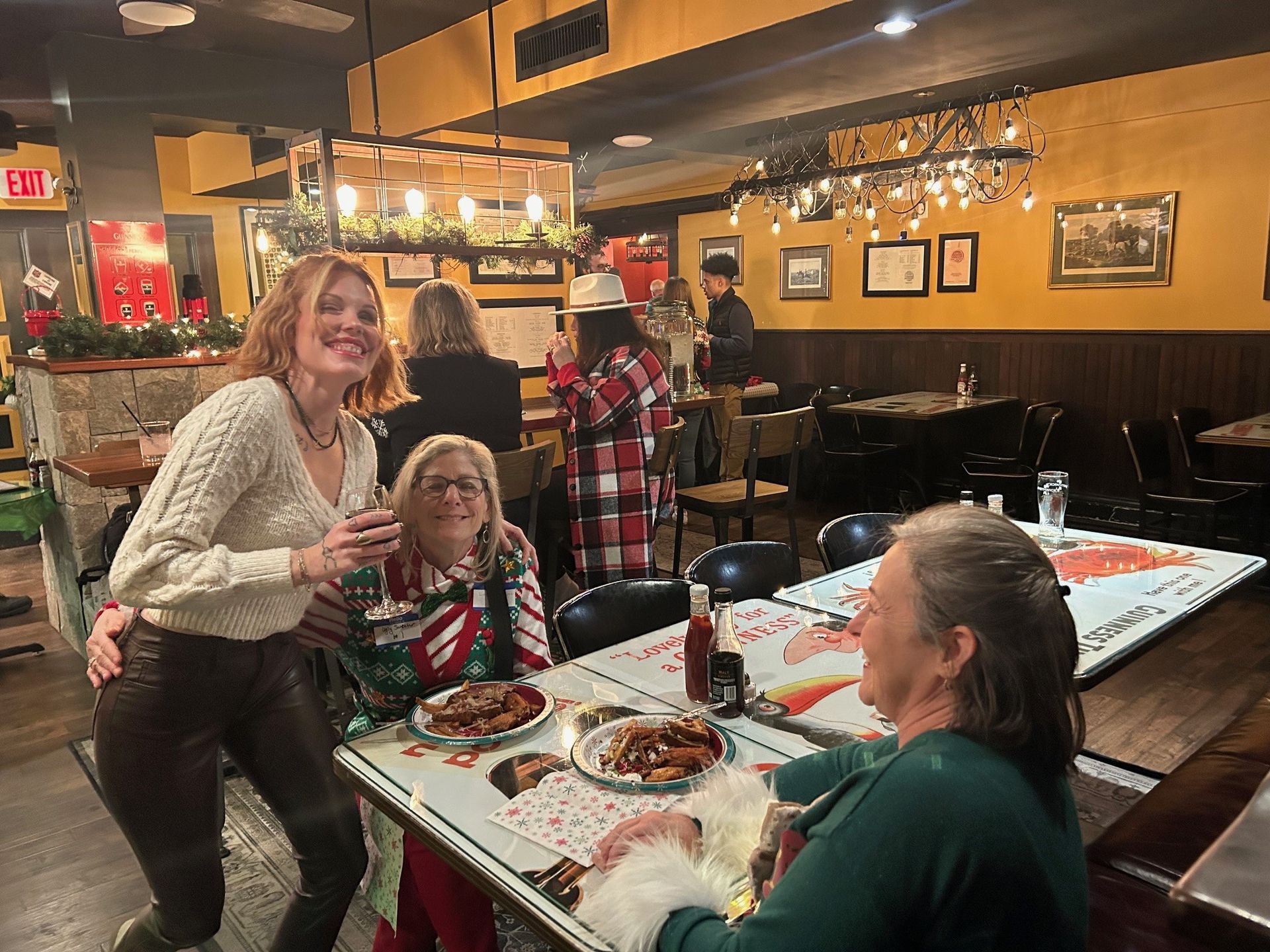 A group of women are sitting at a table in a restaurant.