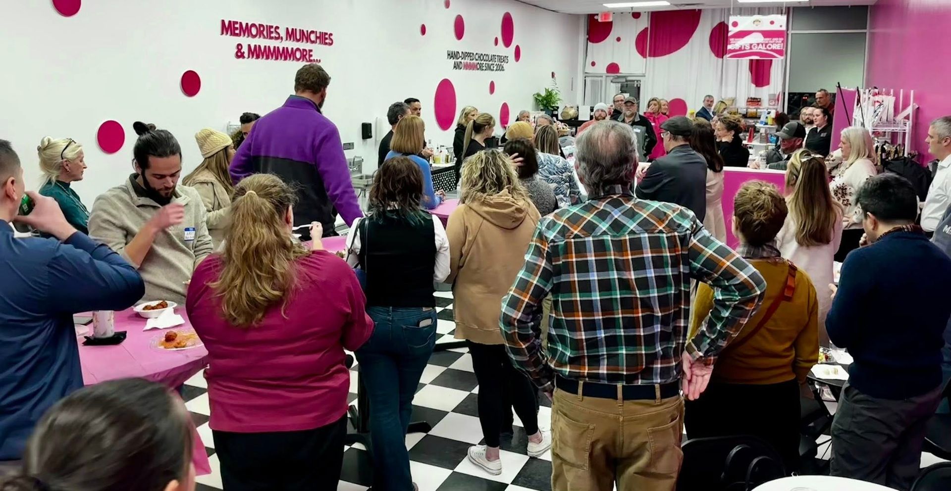 A large group of people part of TBD Connections Networking group are posing for a picture at Thompsons Point.