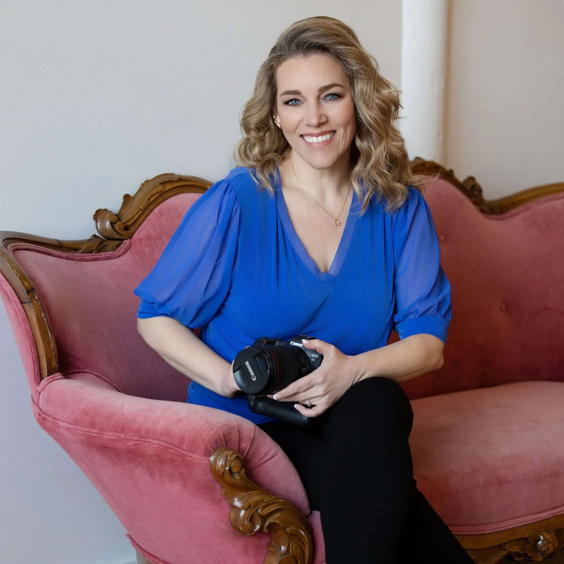 A woman stands in front of a sign that says ls