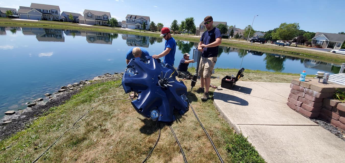 Men Installing Fountain — Chesterton, IN — Lake & Pond Biologists LLC