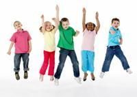 Five children jumping with arms raised, wearing colorful clothes against a white background.