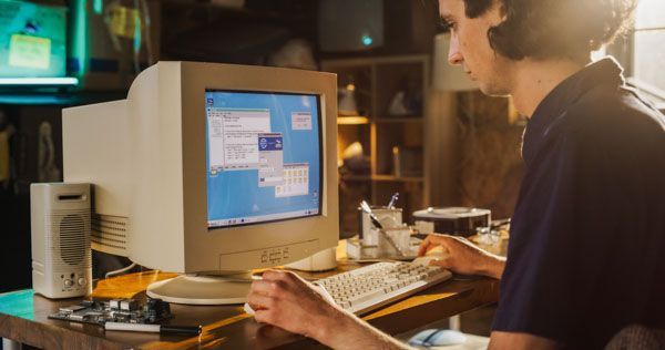 A Caucasian man using 90's desktop computer and internet browser