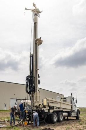 A truck is being used to drill a hole in the ground.