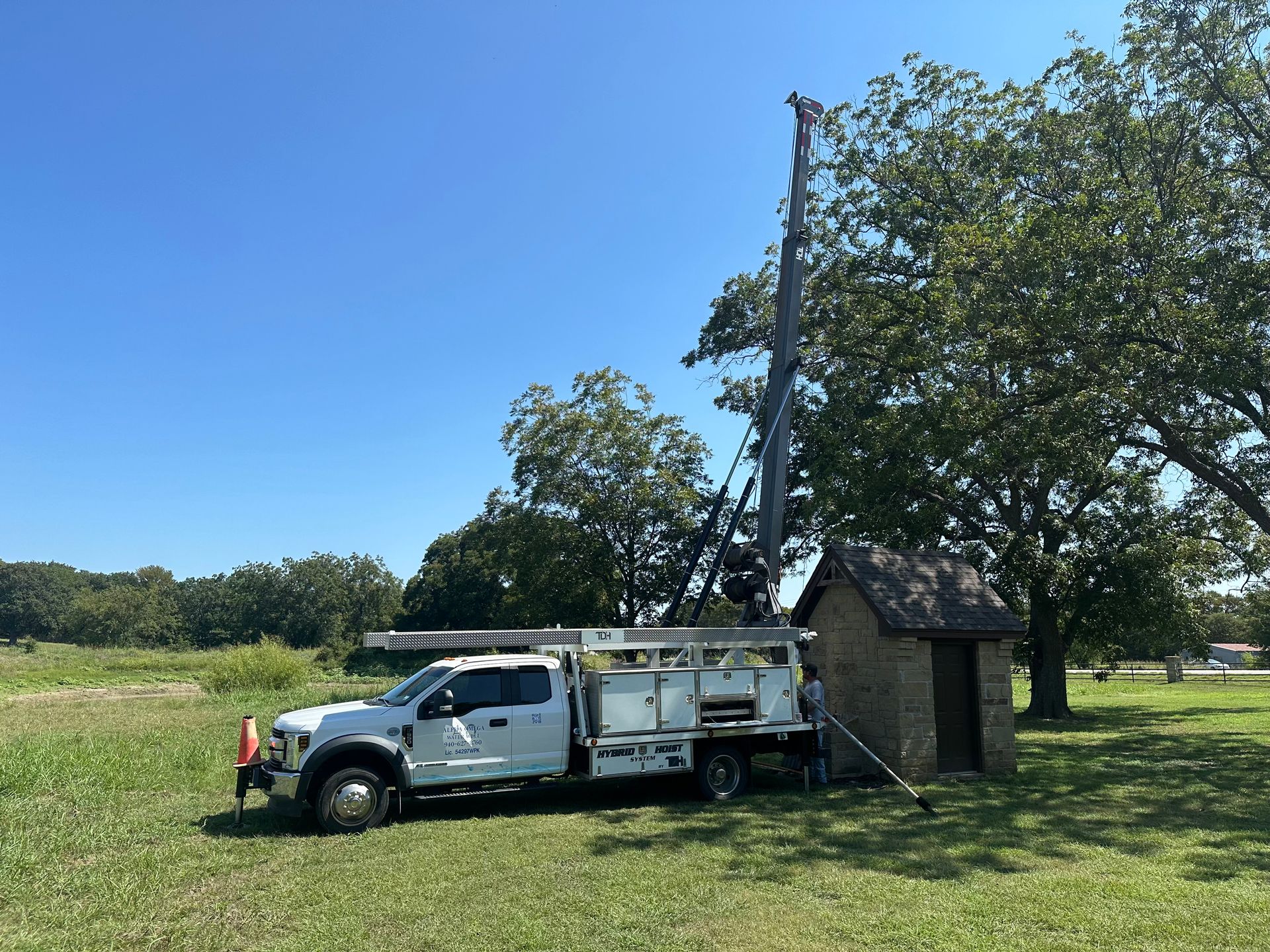 A person wearing gloves is holding a drill bit in their hands.